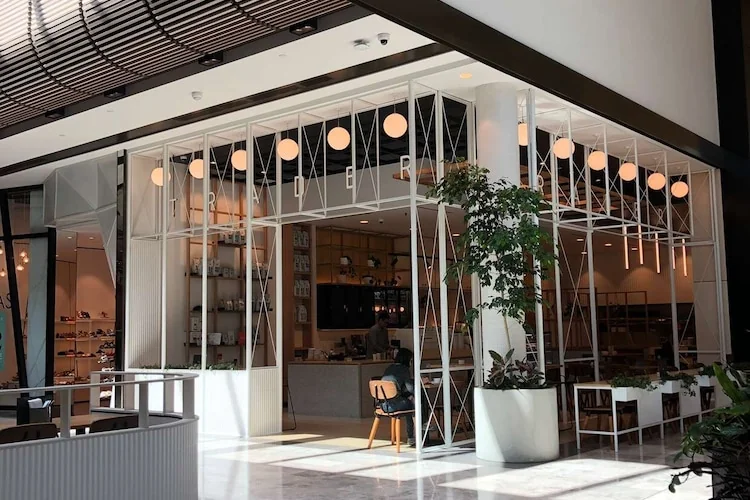 Trader Cafe exterior and interior showcasing modern retail architecture design